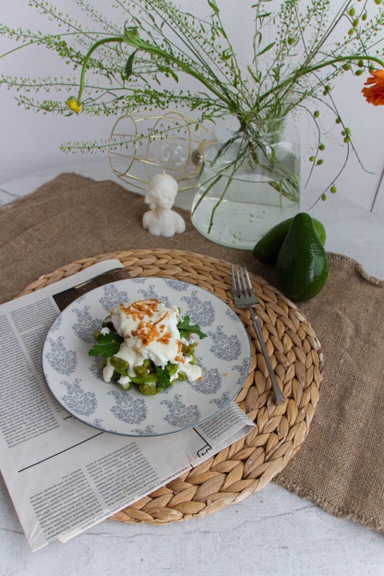 Fresh avocado salad served on a decorative table setting with herbs.